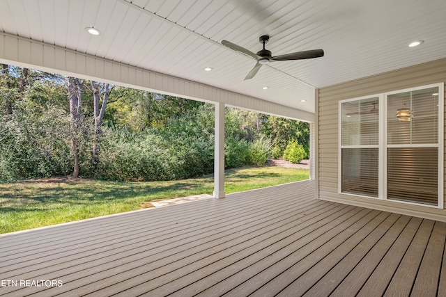 wooden terrace featuring a yard and ceiling fan