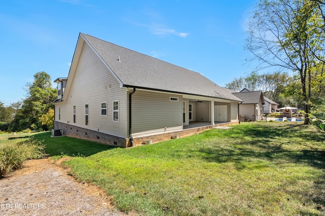 back of house with a patio, central AC, and a yard