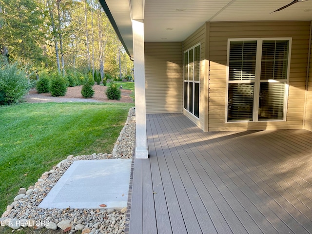 wooden deck featuring a yard