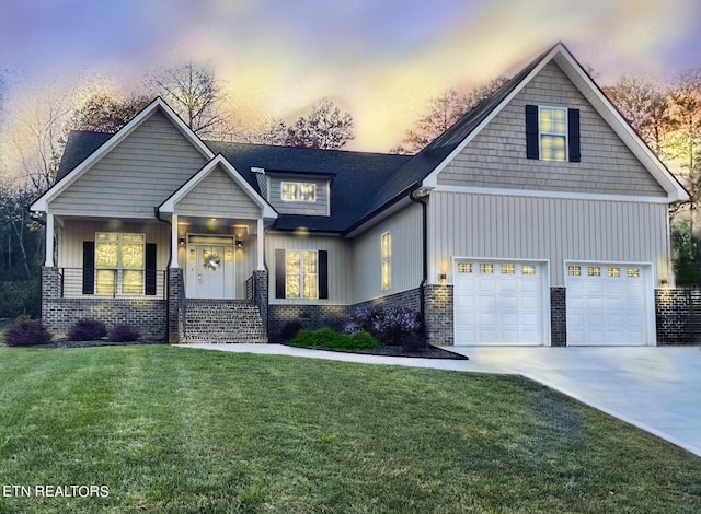 craftsman-style home with a yard, a garage, and a porch