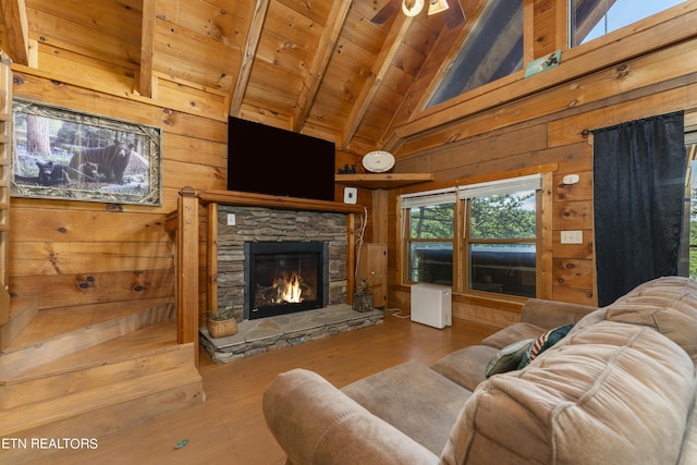 living room with beamed ceiling, a fireplace, wooden ceiling, and wood walls