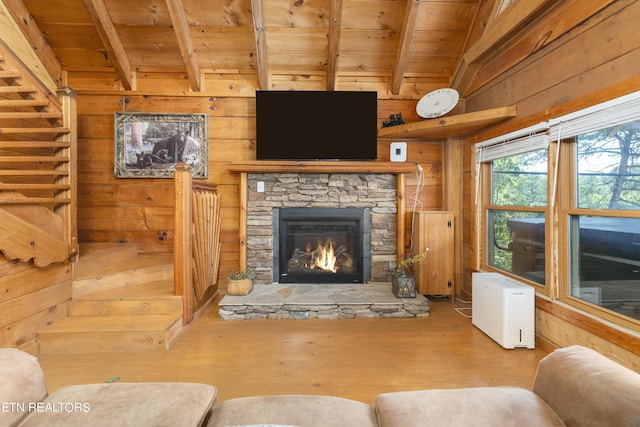 living room featuring vaulted ceiling with beams, wood walls, wood-type flooring, a fireplace, and wood ceiling