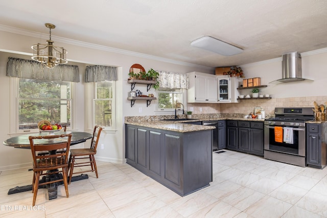 kitchen with open shelves, stainless steel range with gas cooktop, wall chimney range hood, a peninsula, and a sink