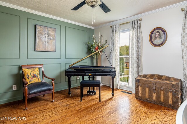 sitting room with ornamental molding, a healthy amount of sunlight, light hardwood / wood-style flooring, and ceiling fan