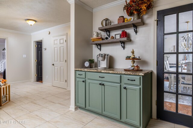 bar featuring ornamental molding, a textured ceiling, and green cabinetry