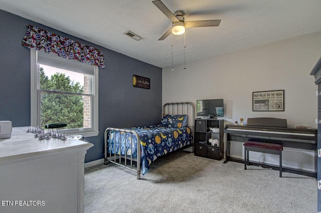 carpeted bedroom with visible vents, a textured ceiling, and ceiling fan