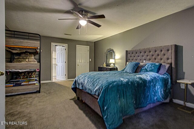 bedroom with carpet flooring, ceiling fan, and a textured ceiling