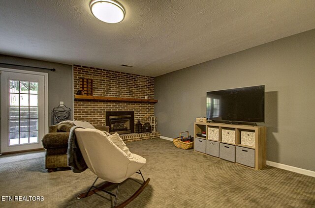 living room with a textured ceiling, a brick fireplace, and carpet floors