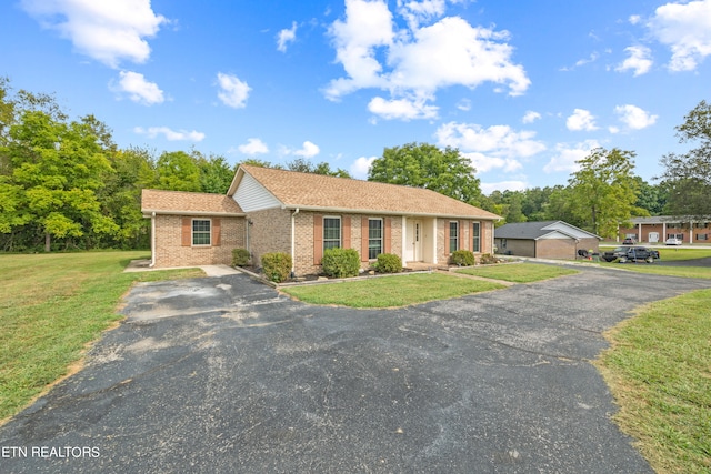 ranch-style home featuring a front yard