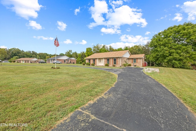 single story home featuring a front yard