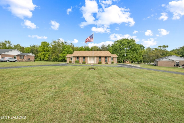 ranch-style home with a front lawn