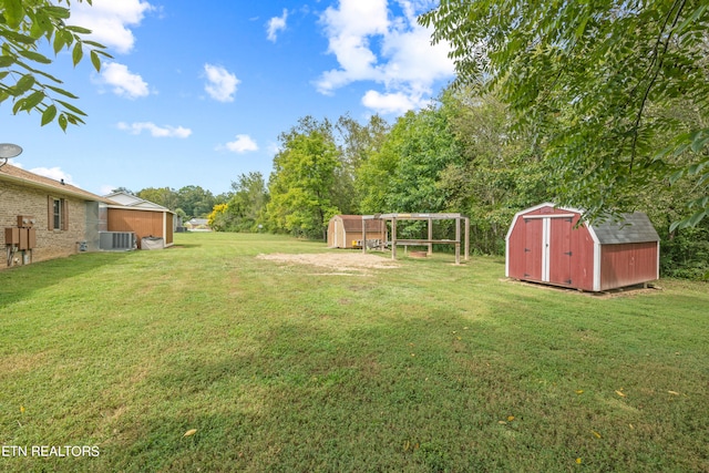 view of yard with central AC and a storage shed