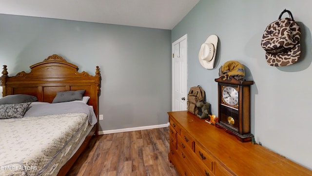 bedroom with dark hardwood / wood-style flooring