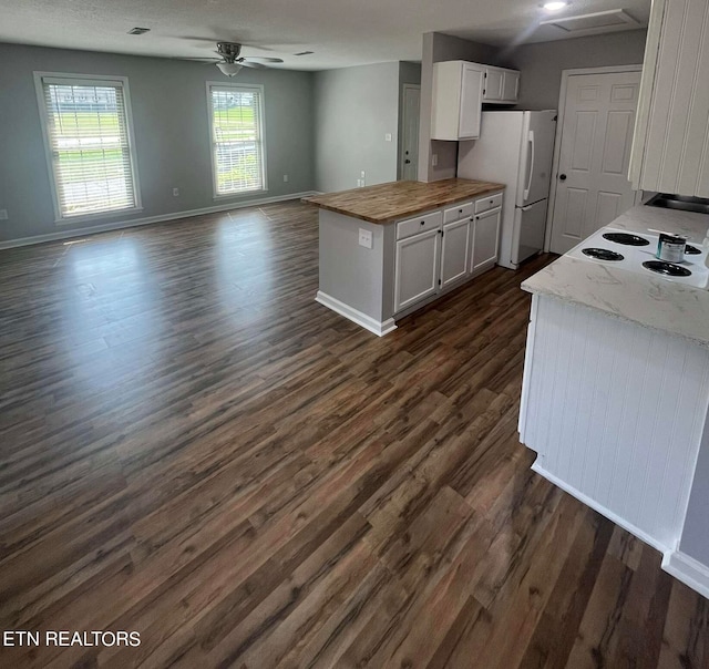 kitchen featuring butcher block countertops, white fridge, dark hardwood / wood-style flooring, and ceiling fan