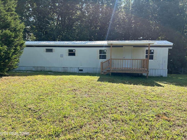 rear view of property with a lawn