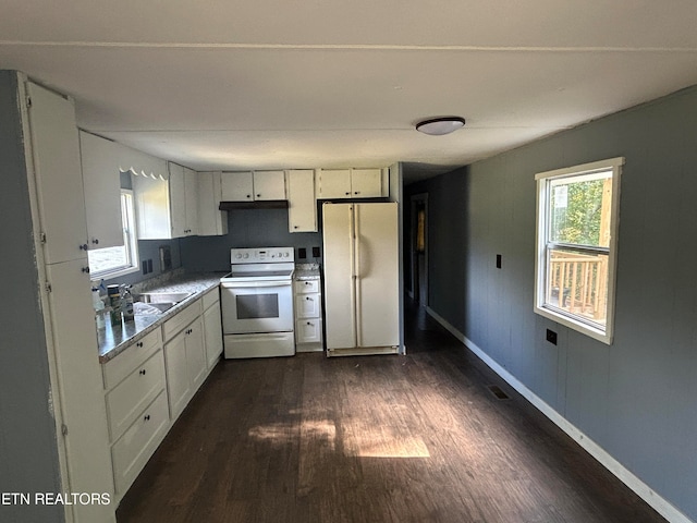 kitchen featuring dark hardwood / wood-style floors, sink, white appliances, and white cabinetry