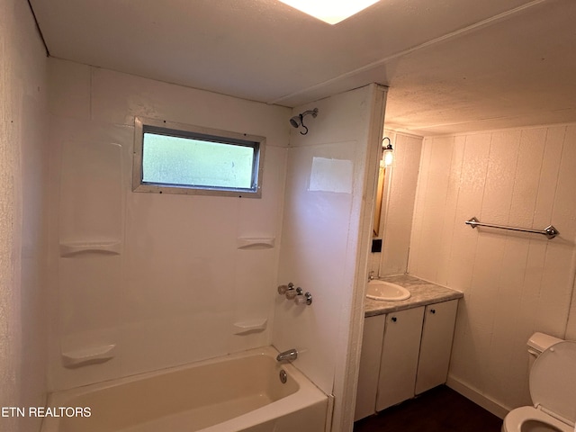 full bathroom with toilet, tub / shower combination, a textured ceiling, and vanity