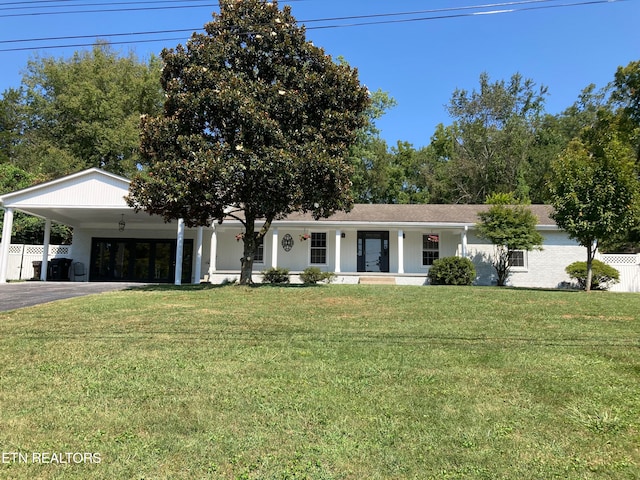 view of front of property with a front lawn and a carport