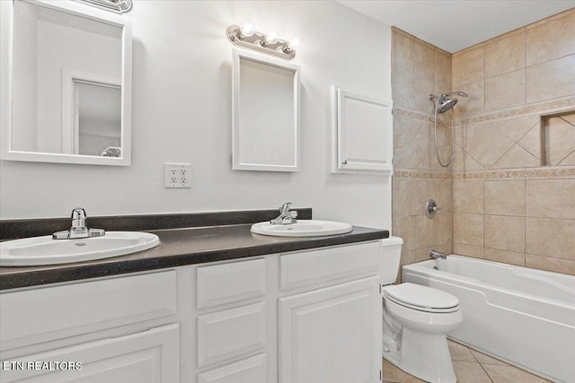 full bathroom with vanity, toilet, tile patterned floors, and tiled shower / bath