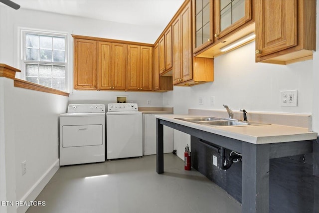 washroom with independent washer and dryer, cabinets, and sink