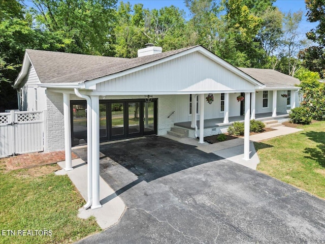 view of front of home with covered porch and a front yard