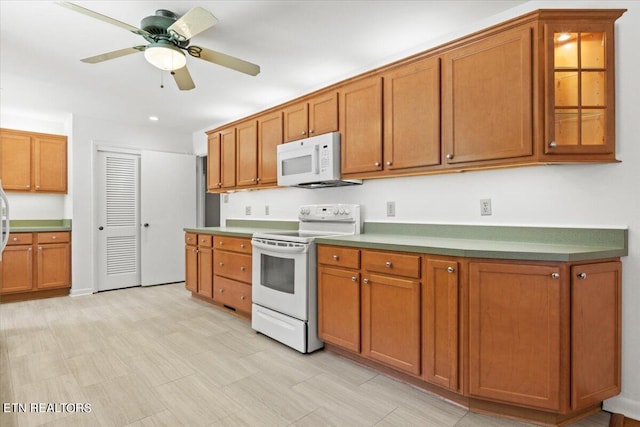 kitchen with white appliances and ceiling fan