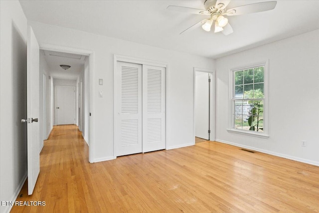 unfurnished bedroom featuring light wood-type flooring, a closet, and ceiling fan