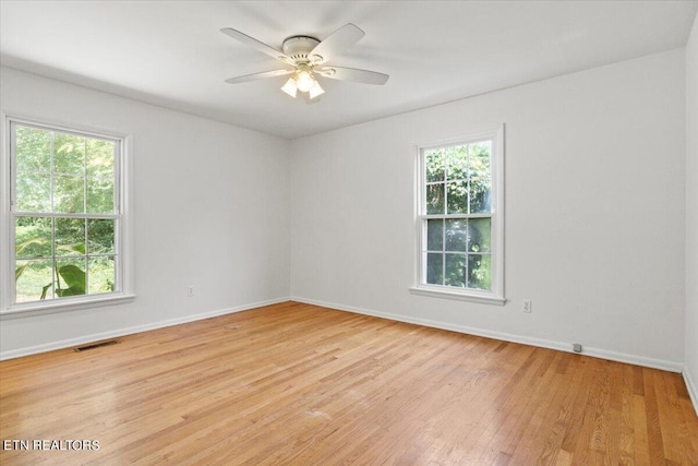 unfurnished room with a healthy amount of sunlight and ceiling fan