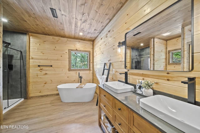 bathroom featuring wood walls, hardwood / wood-style floors, wooden ceiling, and plus walk in shower