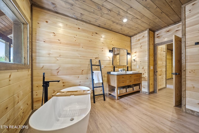 bathroom with vanity, wood ceiling, hardwood / wood-style flooring, wooden walls, and a washtub