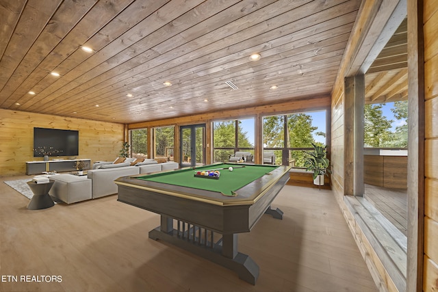 game room with light wood-type flooring, wood ceiling, pool table, and wooden walls