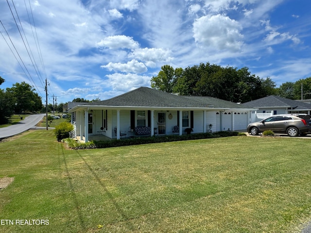 ranch-style home with a front lawn, a garage, and a porch