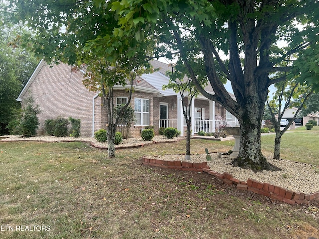 view of front of home featuring covered porch and a front yard