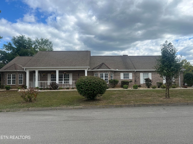 view of front of property with a porch and a front yard