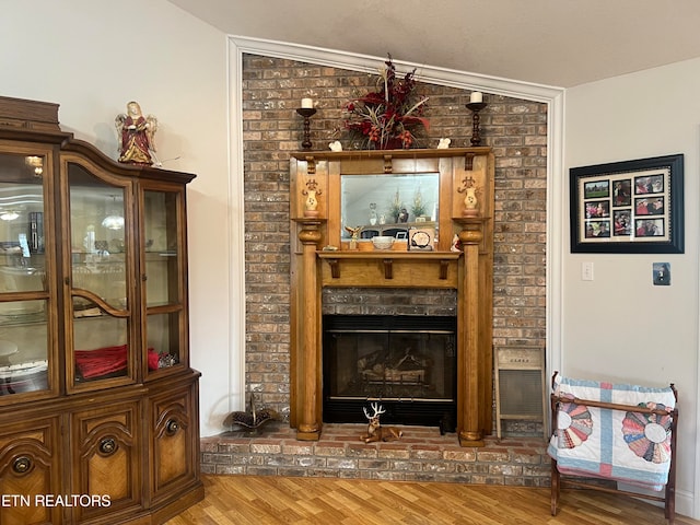 interior space with lofted ceiling, a fireplace, and wood-type flooring