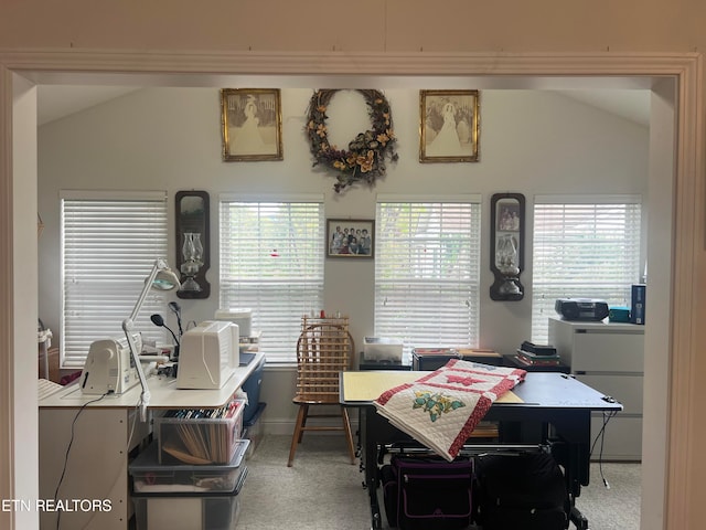 carpeted office featuring vaulted ceiling