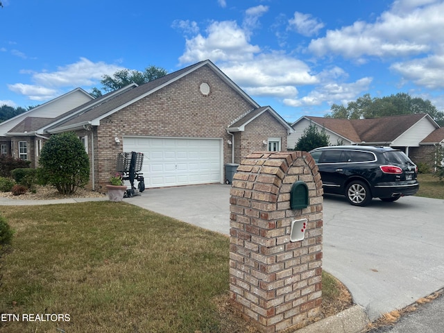 view of side of property with a garage and a lawn