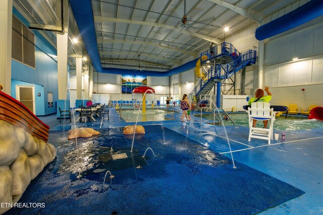 interior space featuring a high ceiling and a swimming pool