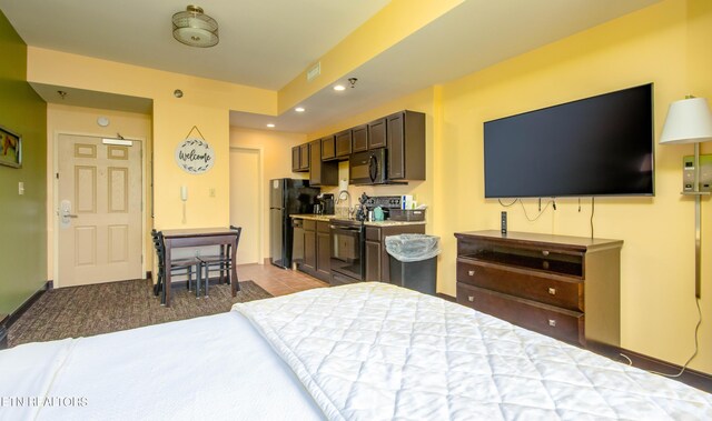 bedroom featuring fridge and light colored carpet