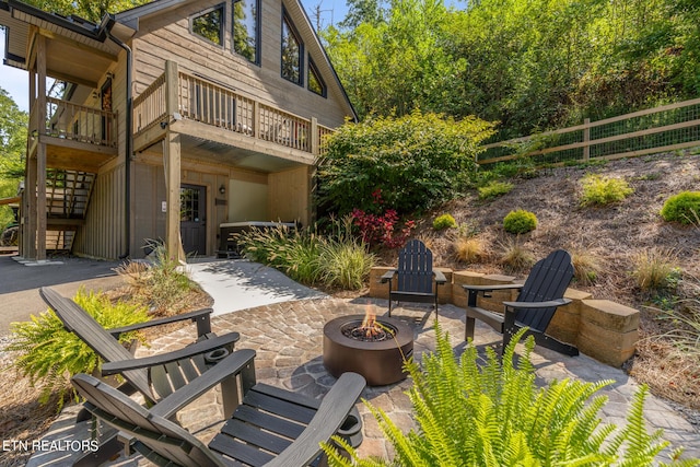 view of patio / terrace featuring an outdoor fire pit and stairs