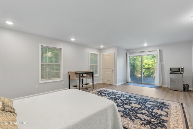 bedroom with access to outside and light wood-type flooring