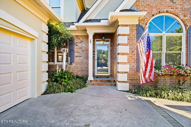 view of exterior entry with a garage