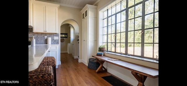 interior space featuring ornamental molding and light hardwood / wood-style floors