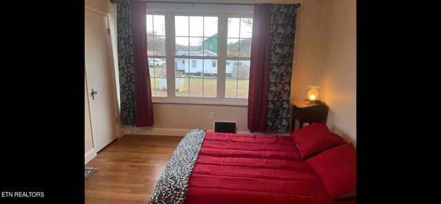 sitting room with hardwood / wood-style flooring