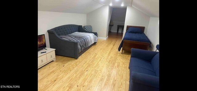 interior space featuring light wood-type flooring and lofted ceiling