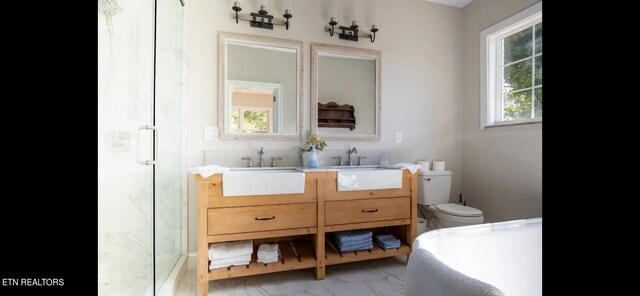 full bathroom featuring independent shower and bath, vanity, toilet, and a healthy amount of sunlight