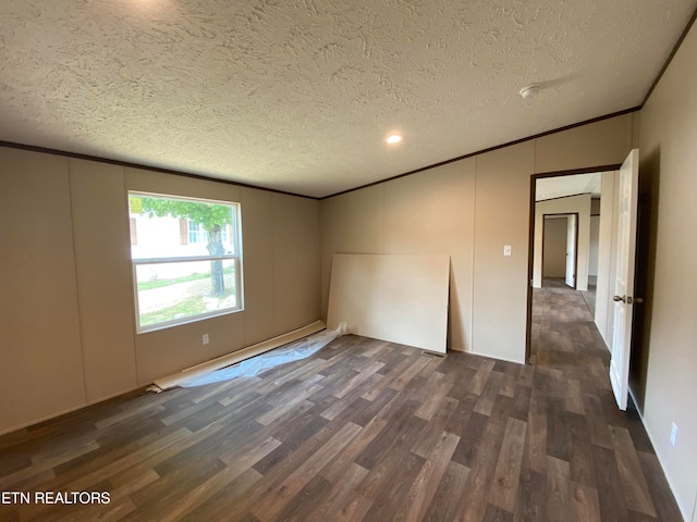 spare room with ornamental molding, a textured ceiling, and dark hardwood / wood-style flooring