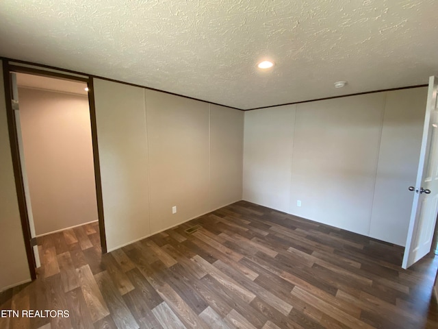 interior space with a textured ceiling and dark wood-type flooring