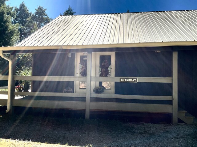 view of side of home featuring metal roof