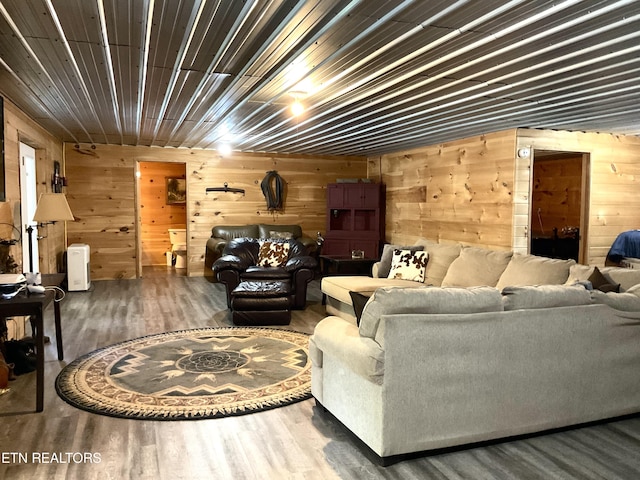 living room with wood walls and wood finished floors